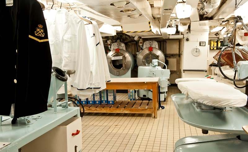 The Laundry Room aboard The Royal Yacht Britannia showing shirts, jackets and ironing equipment