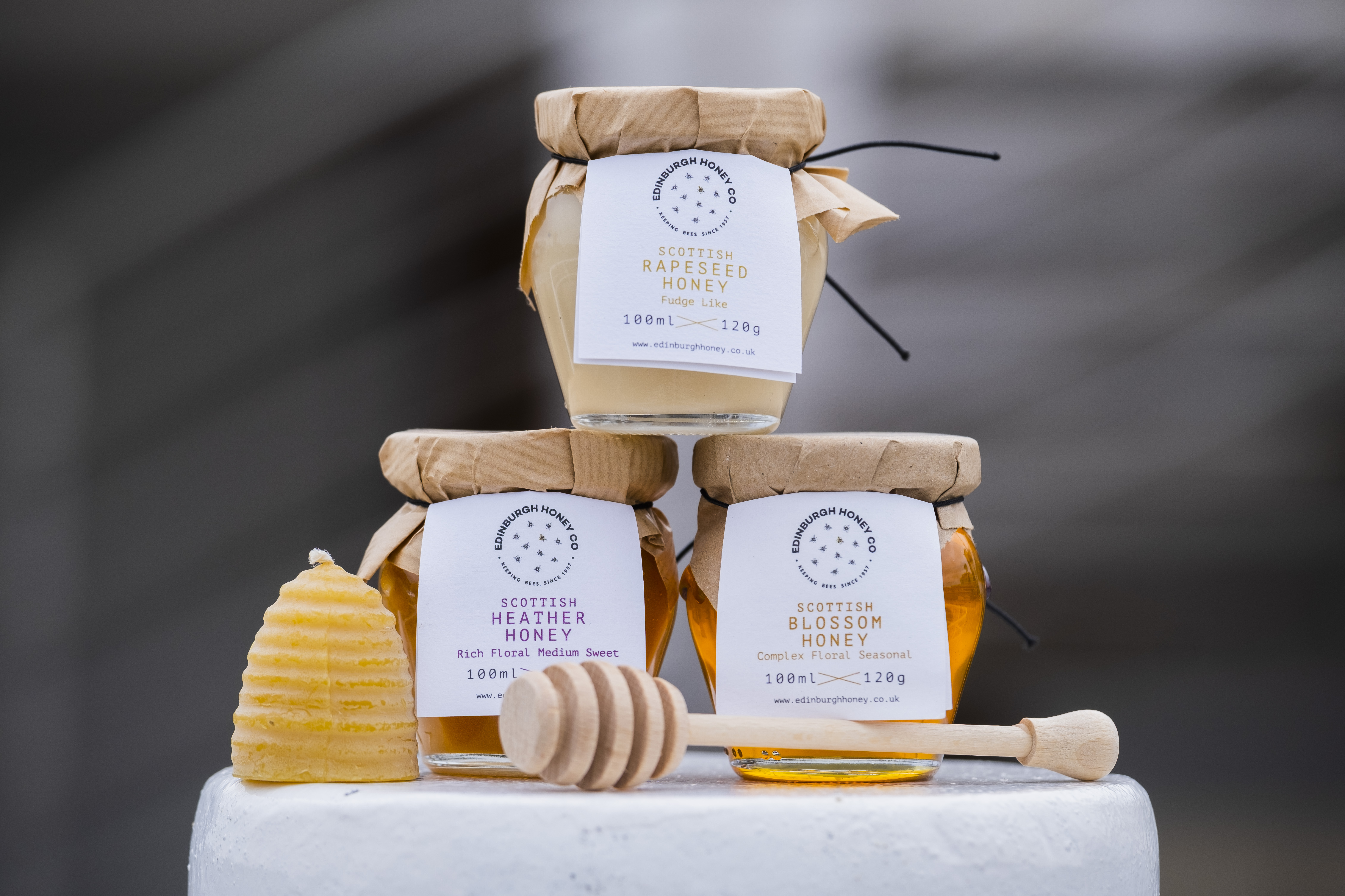 A pyramid of three jars of honey