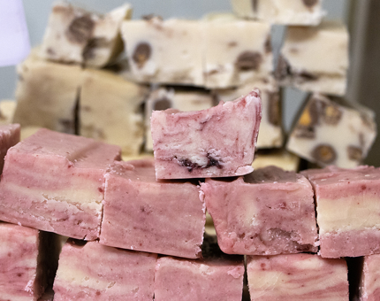 Slabs of pink coloured raspberry ripple fudge in the NAAFI. 