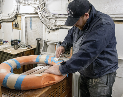 A man from the Maintenance Team adding filler to a Perrybuoy. 