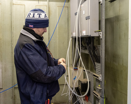 A man working on internet cabling. 