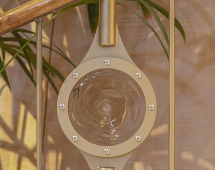 A detail of the bulls-eye glass in the gold-coloured stair railing. 