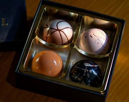 A box containing individually hand-crafted chocolates. 