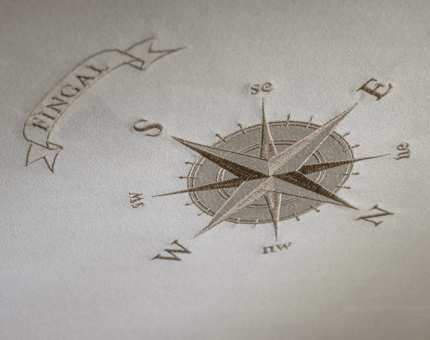 A detail of a compass on the suede ceiling of a cabin at Fingal. 