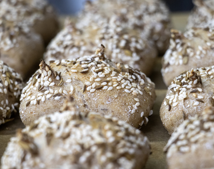 A close-up of seeded wholemeal bread rolls. 