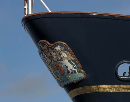 The bow of Britannia displaying the Royal Coat of Arms. 