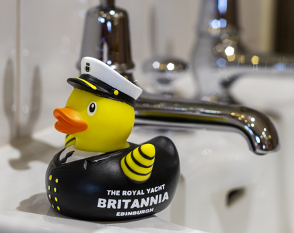 A novelty Captain rubber duck sitting on a wash basin. 