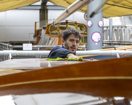 A team member polishing the top of Coweslip. 