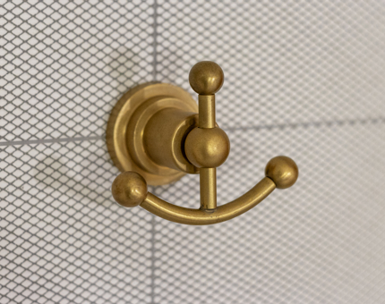 A golden coat hook in the bathroom inside one of Fingal's cabins. 