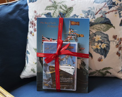A Britannia guide book and DVD packaged together with a red bow. 
