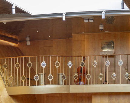 The Musician's Gallery in Fingal Hotel's Ballroom, there is a cello and a saxophone against the back wall.  