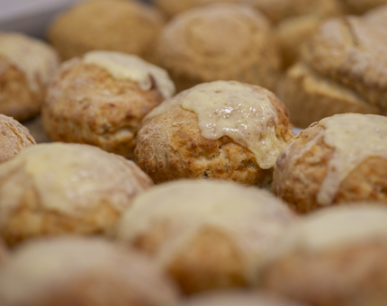 A close-up of a tray of cheese scones. 