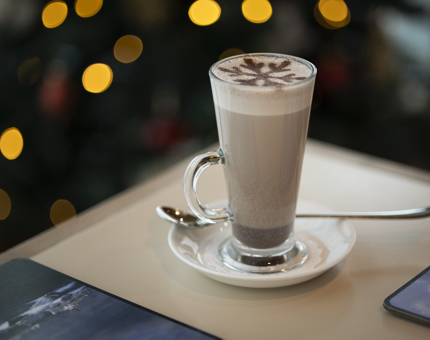 A hot chocolate with a chocolate star stencil on top. 