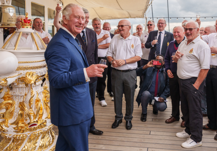 HM The King on the Verandah Deck raising a glass