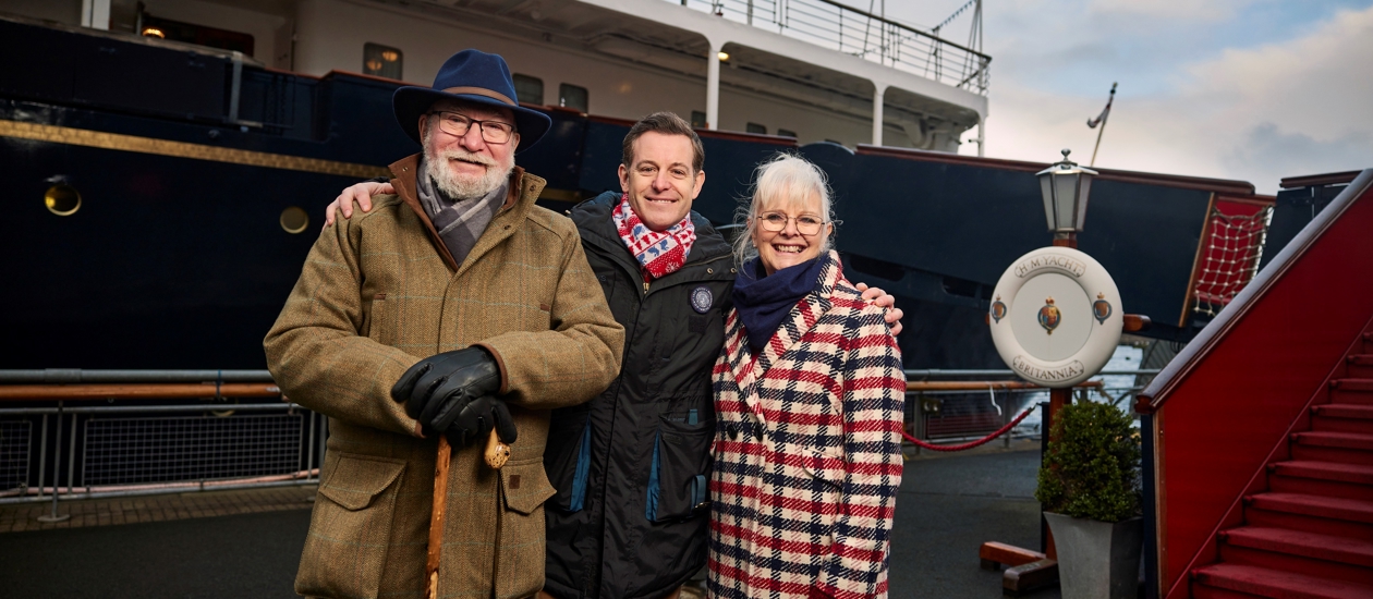 The Royal Yacht Britannia from the quayside, Matt Baker and his mum and dad are standing in front of the ship. 