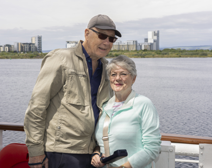 Two people standing together on board Britannia in the Port of Leith. 