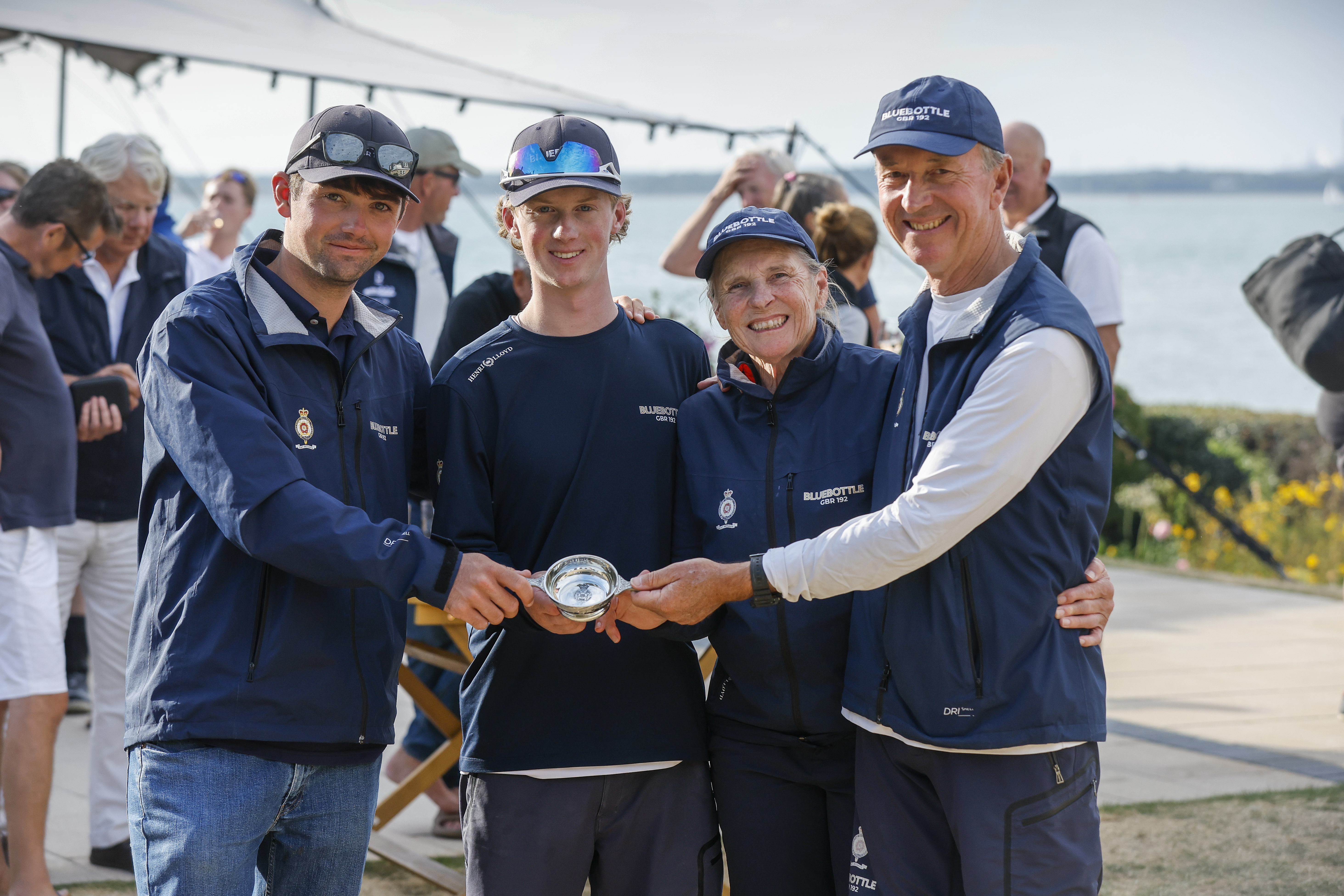 Four people smiling holding an award.