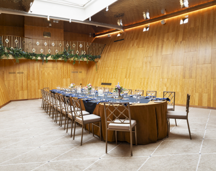 A wide shot of Fingal's Ballroom with a long table set in the middle. 