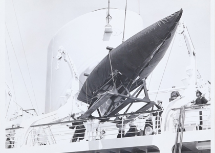 Royal Racing Yacht Bluebottle being hoisted onto Britannia. 