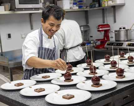 A chef is in Britannia's Galley preparing Black Forest Gateaux for an exclusive dinner on board. 
