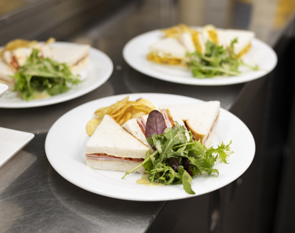 Ham & Tomato Sandwiches on a plate, ready to be served in Britannia's Galley. 