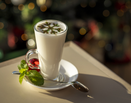 A peppermint white hot chocolate with a chocolate snowflake design on top. 