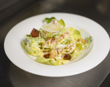A bowl of Caesar salad.