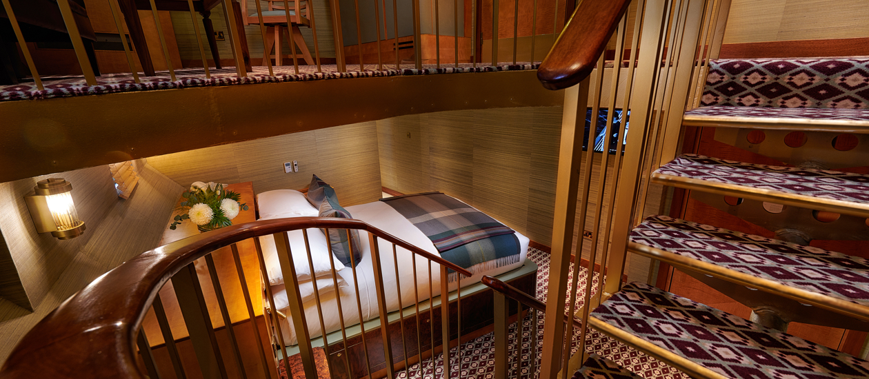 bed and spiral staircase showing the room