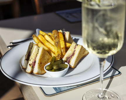 In the Royal Deck Tearoom, there is a Reuben Sandwich with fries, pickles and a spritz drink. 