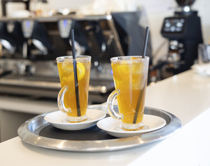Two glasses of iced tea on a tray in the Tearoom aboard Britannia. 
