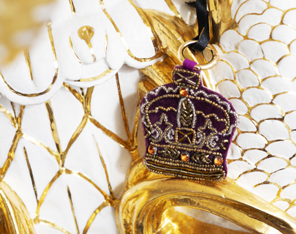 A beaded embroidered Crown bag charm. 