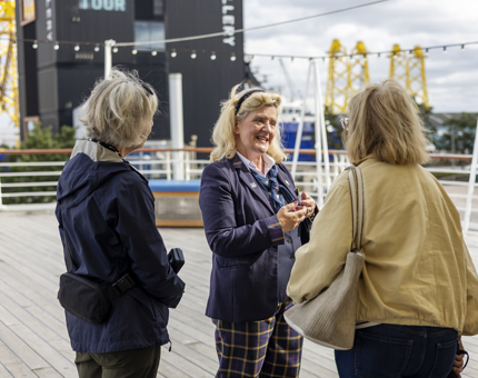 Lesley, Visitor Assistant, Chats To Visitors On The Verandah Deck in the Port of Leith. 