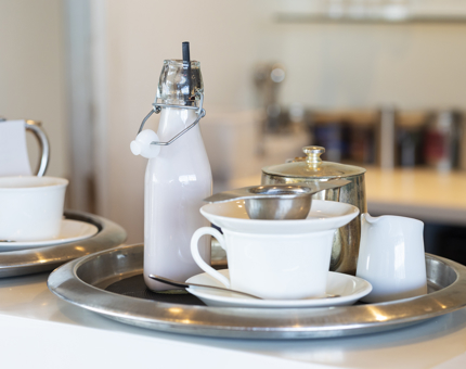 A tray is on the bar in the Tearoom aboard Britannia with a selection of drinks on it. 