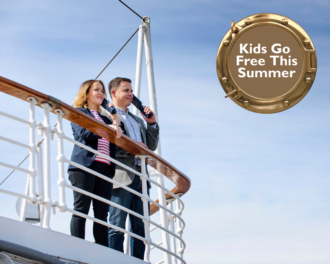 Two people stand on the upper deck of a cruise ship beside a white metal railing, looking out over the water under a clear blue sky.