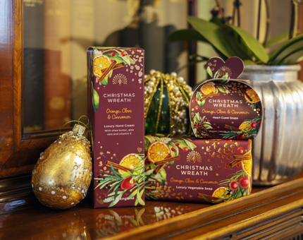 A selection of Christmas Wreath Orange, Clove & Cinnamon Hand Cream And Soaps. 