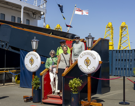 Four Visitors standing on the Royal Brow enjoying a sunny day in the Port of Leith. 