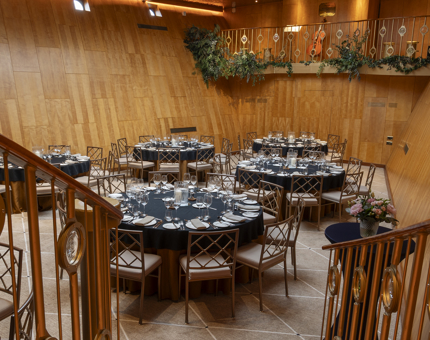The Ballroom aboard Fingal Hotel with round tables for a dinner. 
