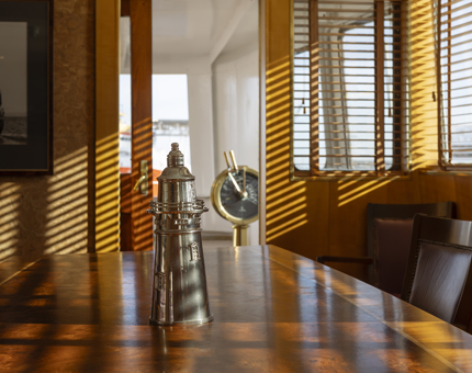 The Bridge of Fingal Hotel. On the table there is a silver lighthouse in the middle. 