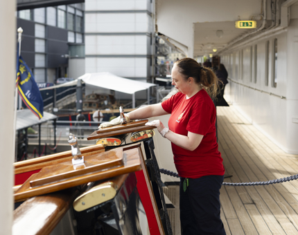 A Housekeeper is Cleaning The Top Of The Royal Brow aboard Britannia in Leith. 