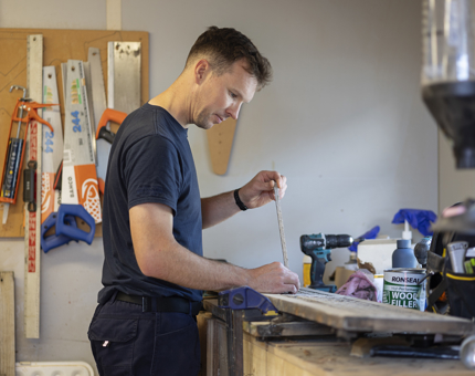 A Maintenance team member removing sections of damaged wood from the Verandah Decks slats. 