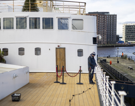 On Fingal Hotel in Leith, a maintenance team member is installing lighting on the deck. 