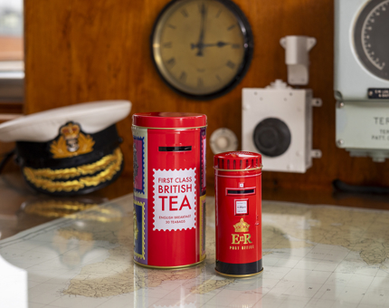 Two tins of tea, designed to look like red post boxes. 