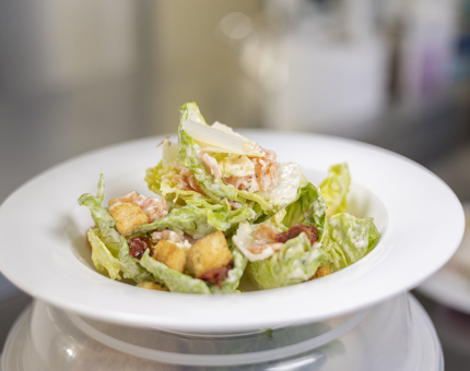 A bowl of Caesar salad in Britannia's Galley.