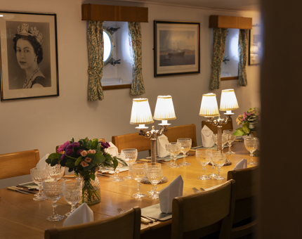 The Officers' Wardroom set for a dinner aboard. 