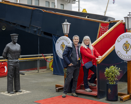 Two visitors posing for a photo at the Royal Brow at The Royal Yacht Britannia. 