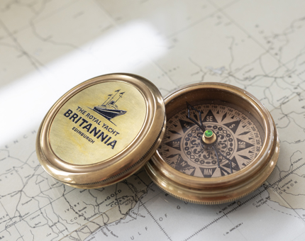 A Britannia Compass sitting on a map. 