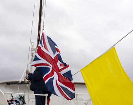 A Union Jack flag is being raised at Britannia's Bow in the Port of Leith. 