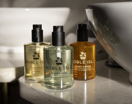 Three bottles of Noble Isle bath and body products. 