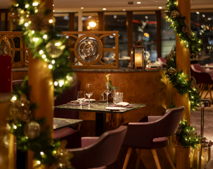 The Lighthouse Restaurant is decorated for Christmas with garlands and lights. 