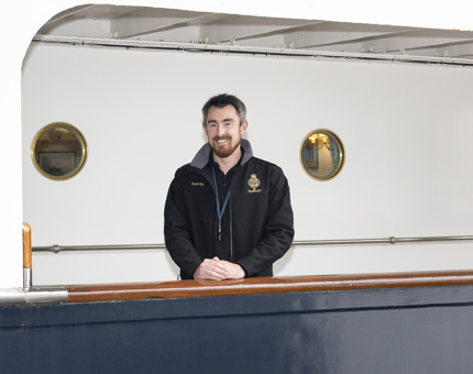 Mark, The New Safety & Security Team Leader is standing on the Shelter Deck on Britannia in Leith. 